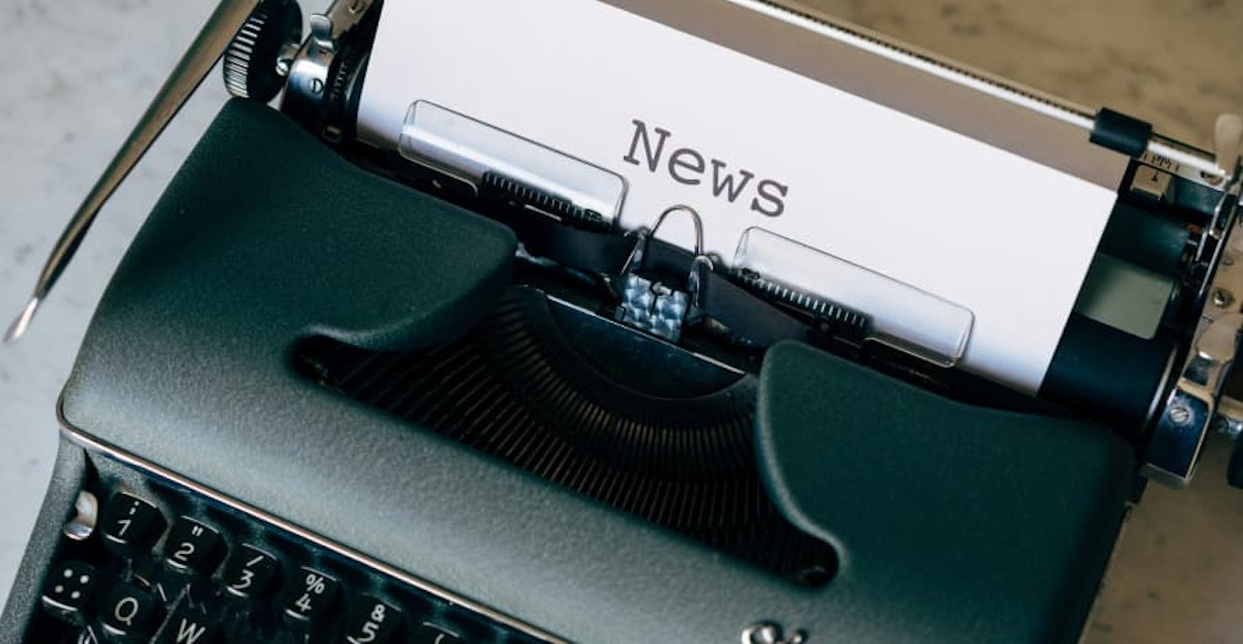 typewriter that says, "news"