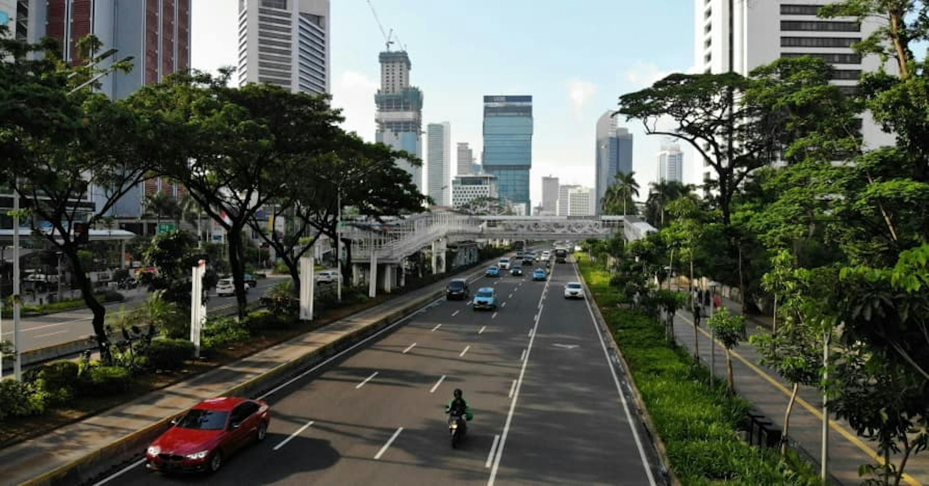 cars driving on open road in business district