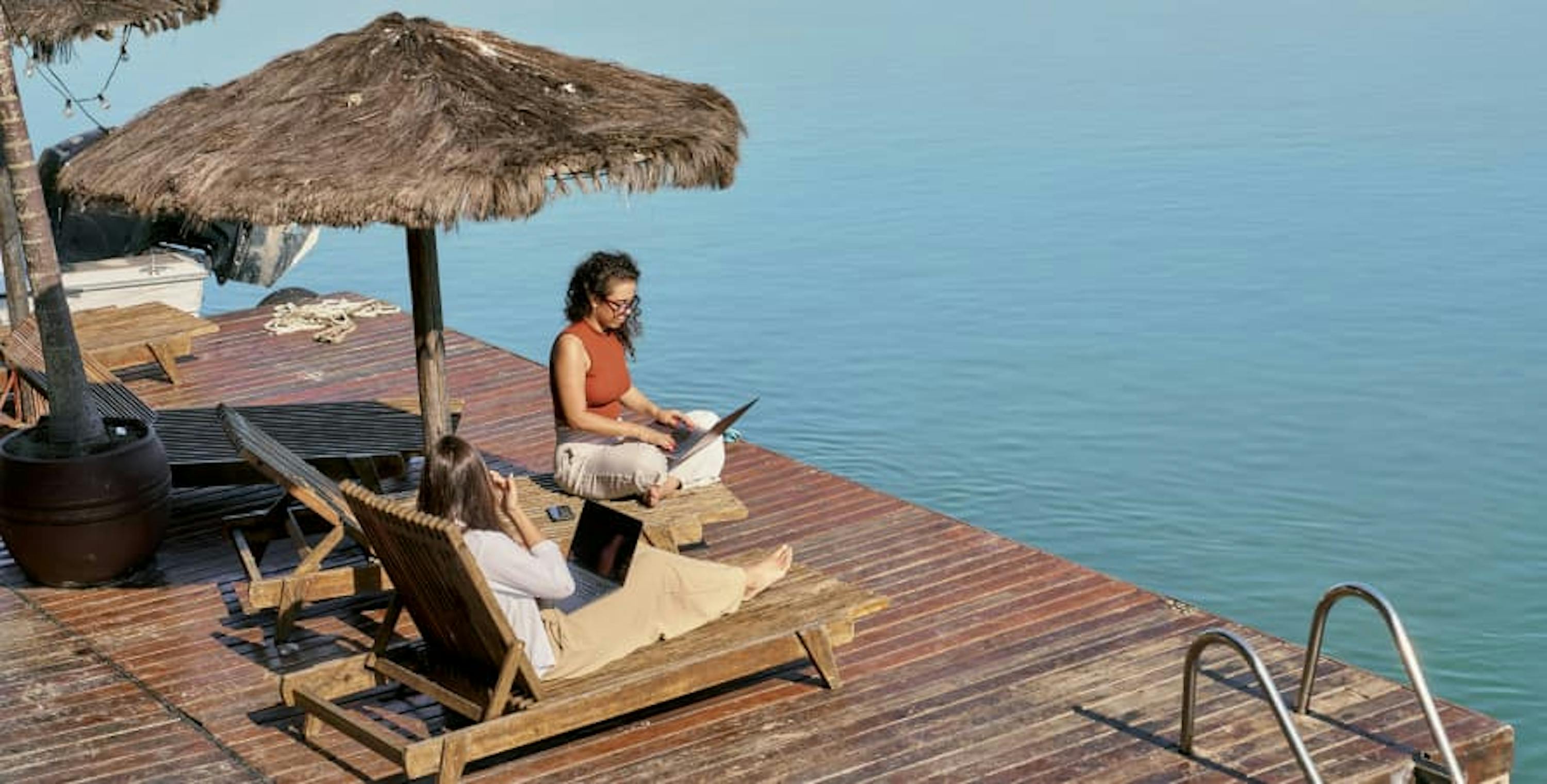 digital nomads working by the water