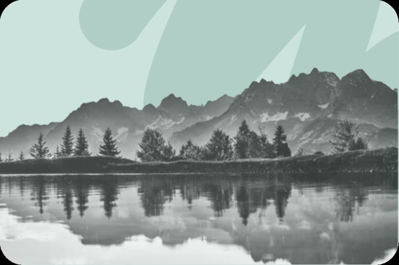 view of mountains and trees on water