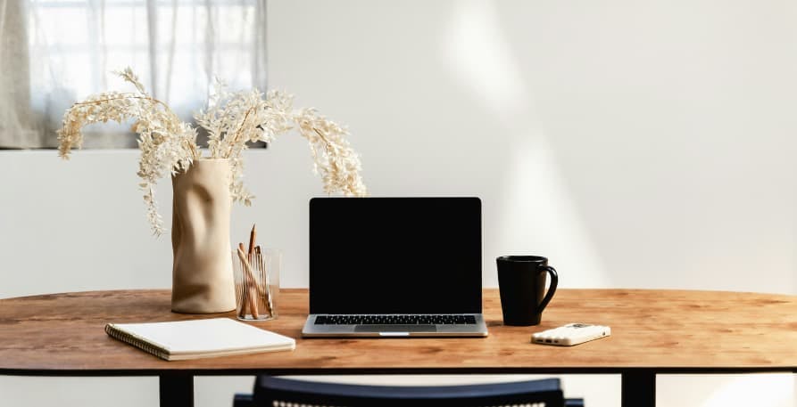 laptop on brown desk