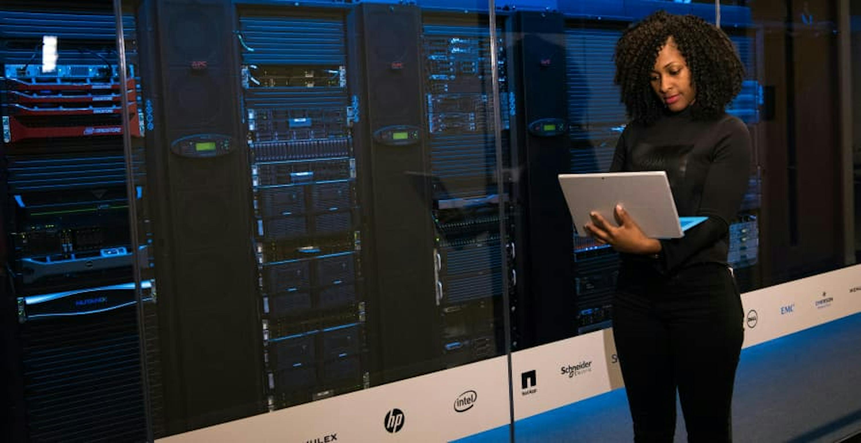 woman standing in front of computer processors