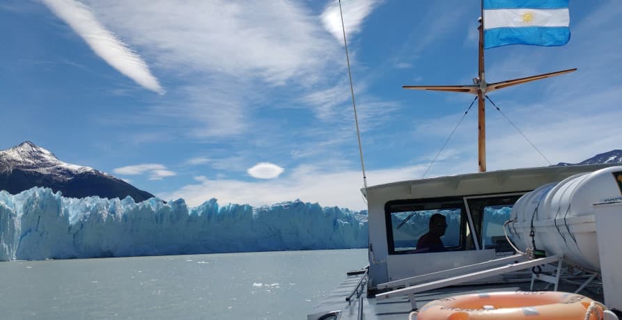 scientific boat observing a glacier from the ocean