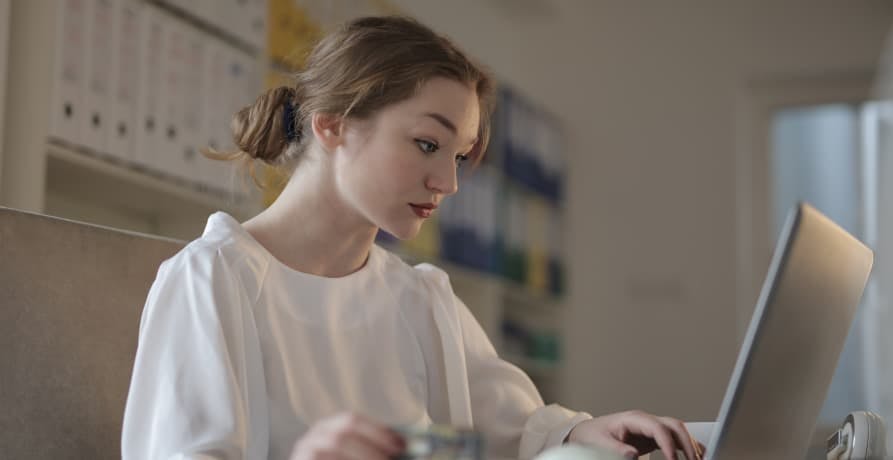 woman sitting at laptop in office