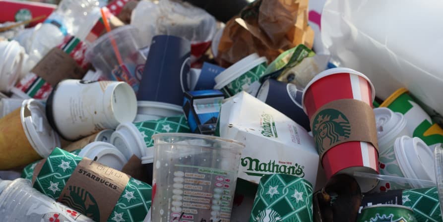 starbucks and other plastic cups piled up