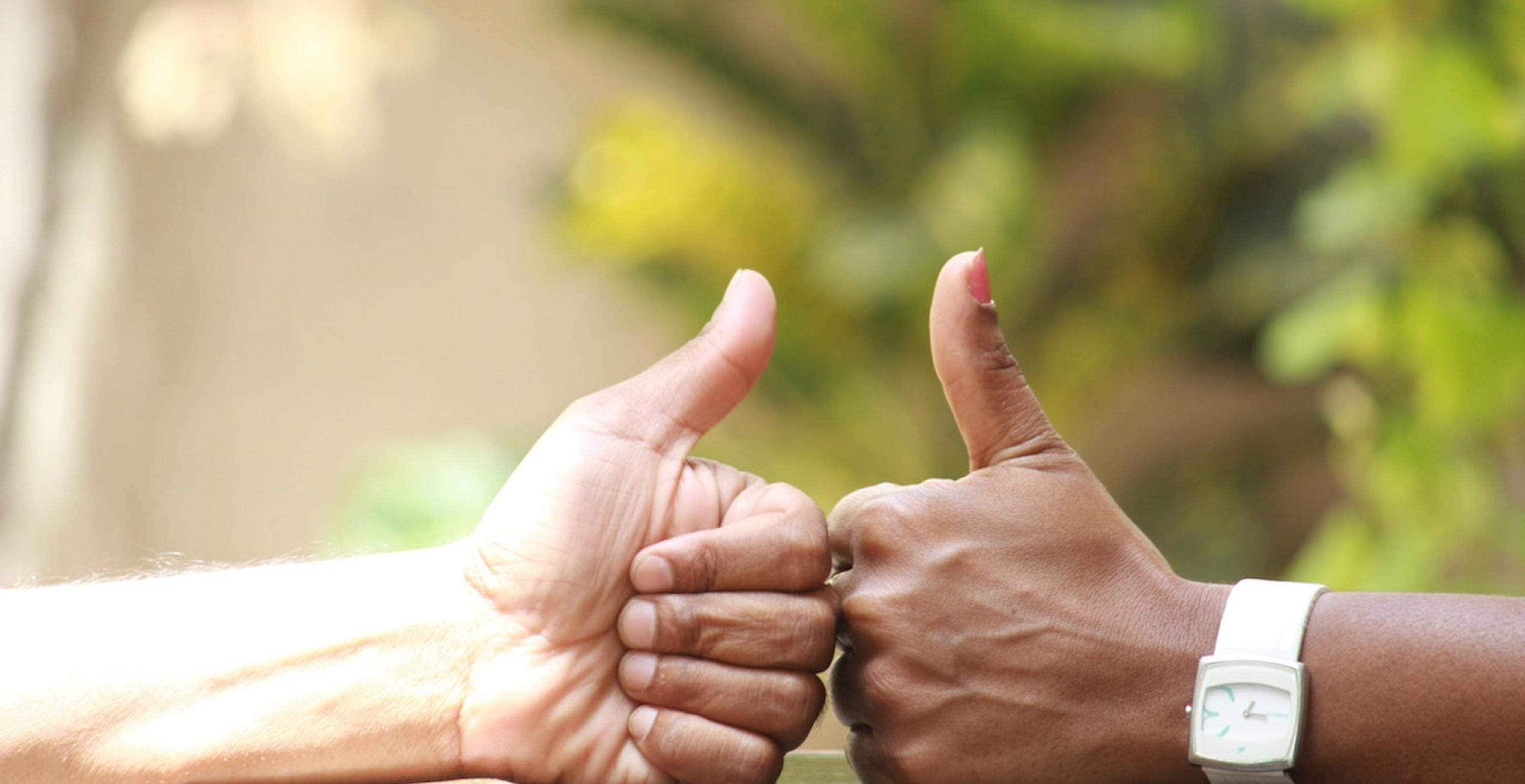 two hands giving a thumbs up