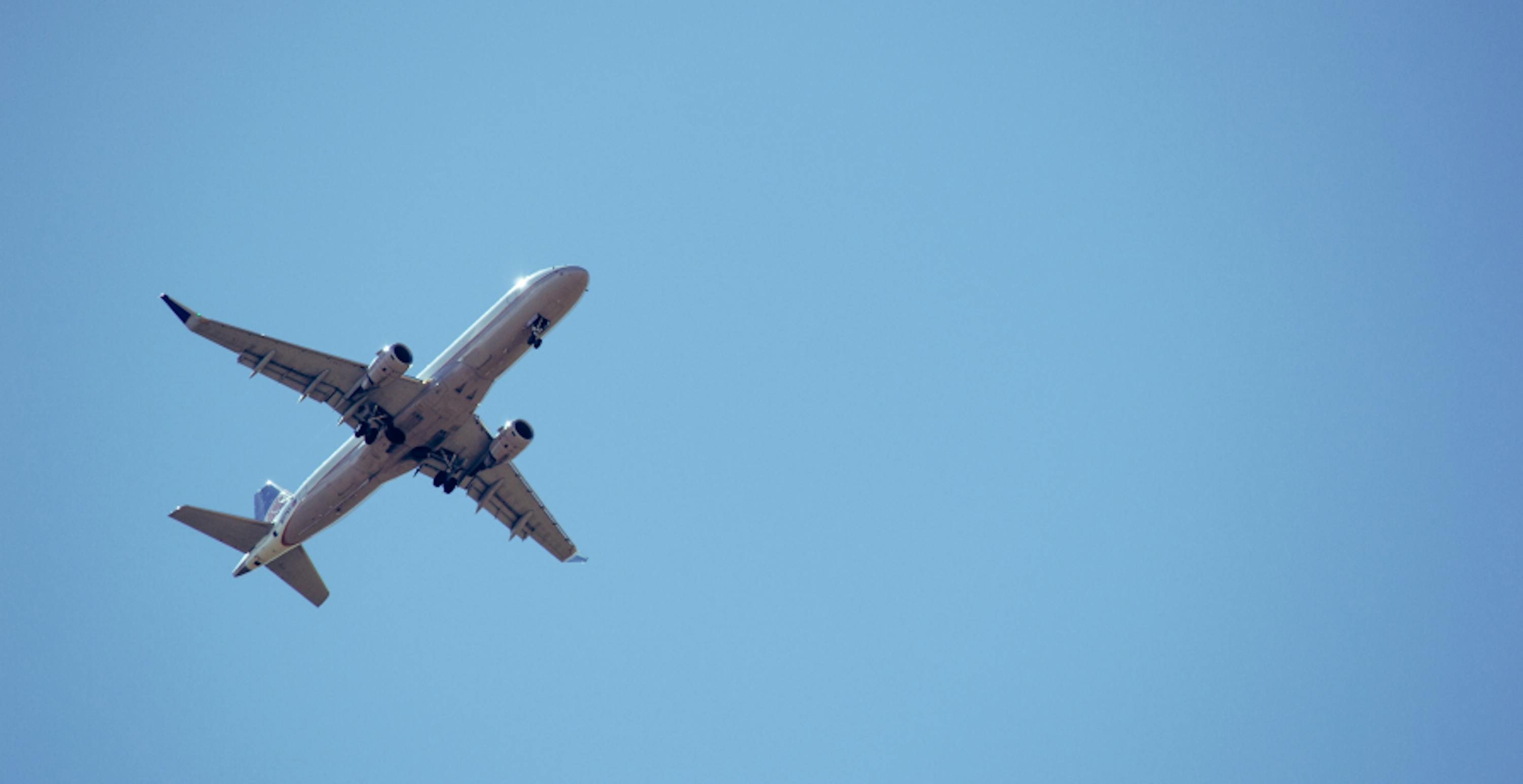 plane flying in blue skies