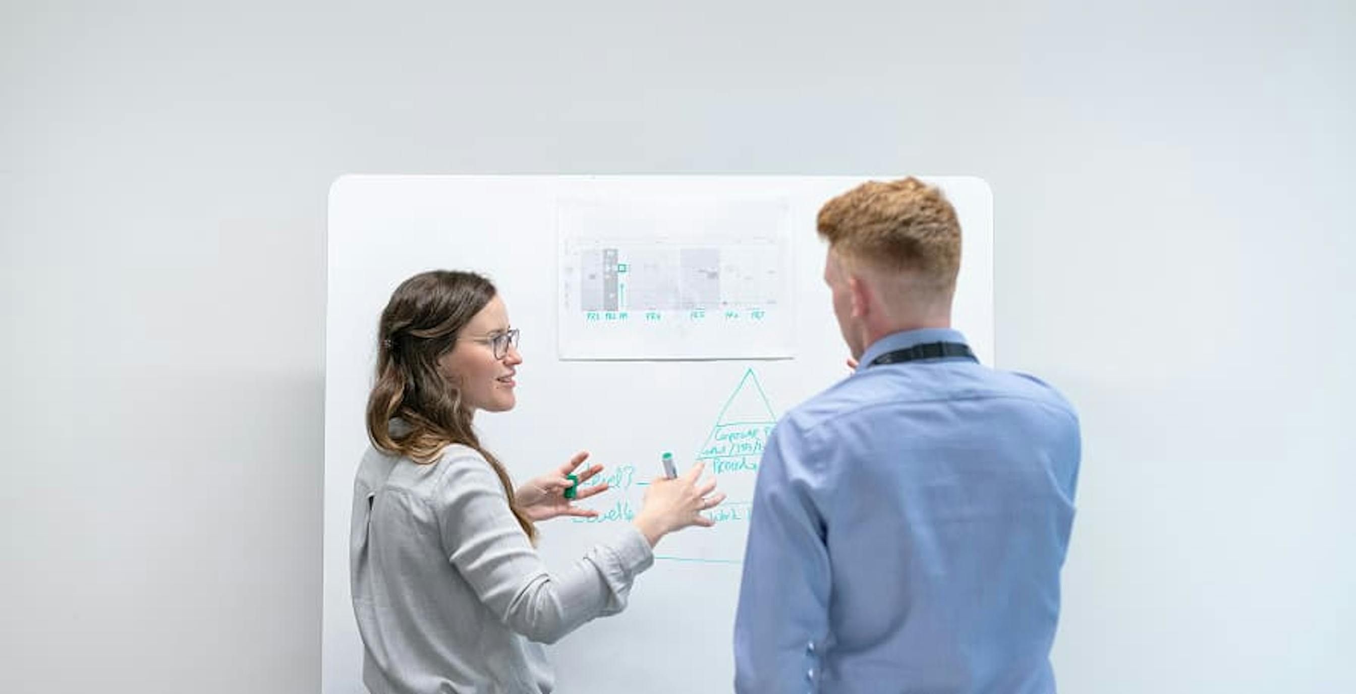 people discussing in front of board