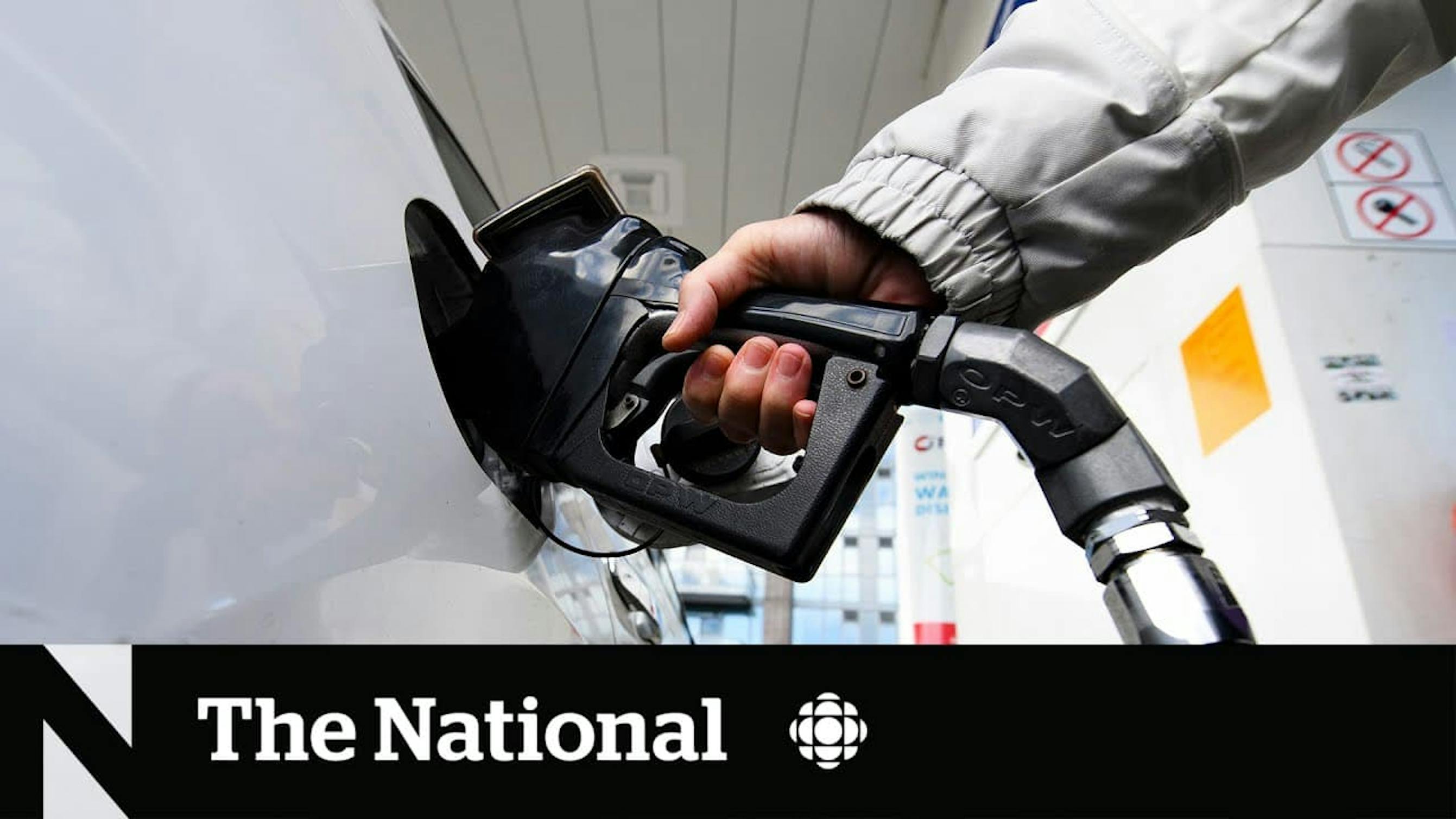 person filling up car with gas
