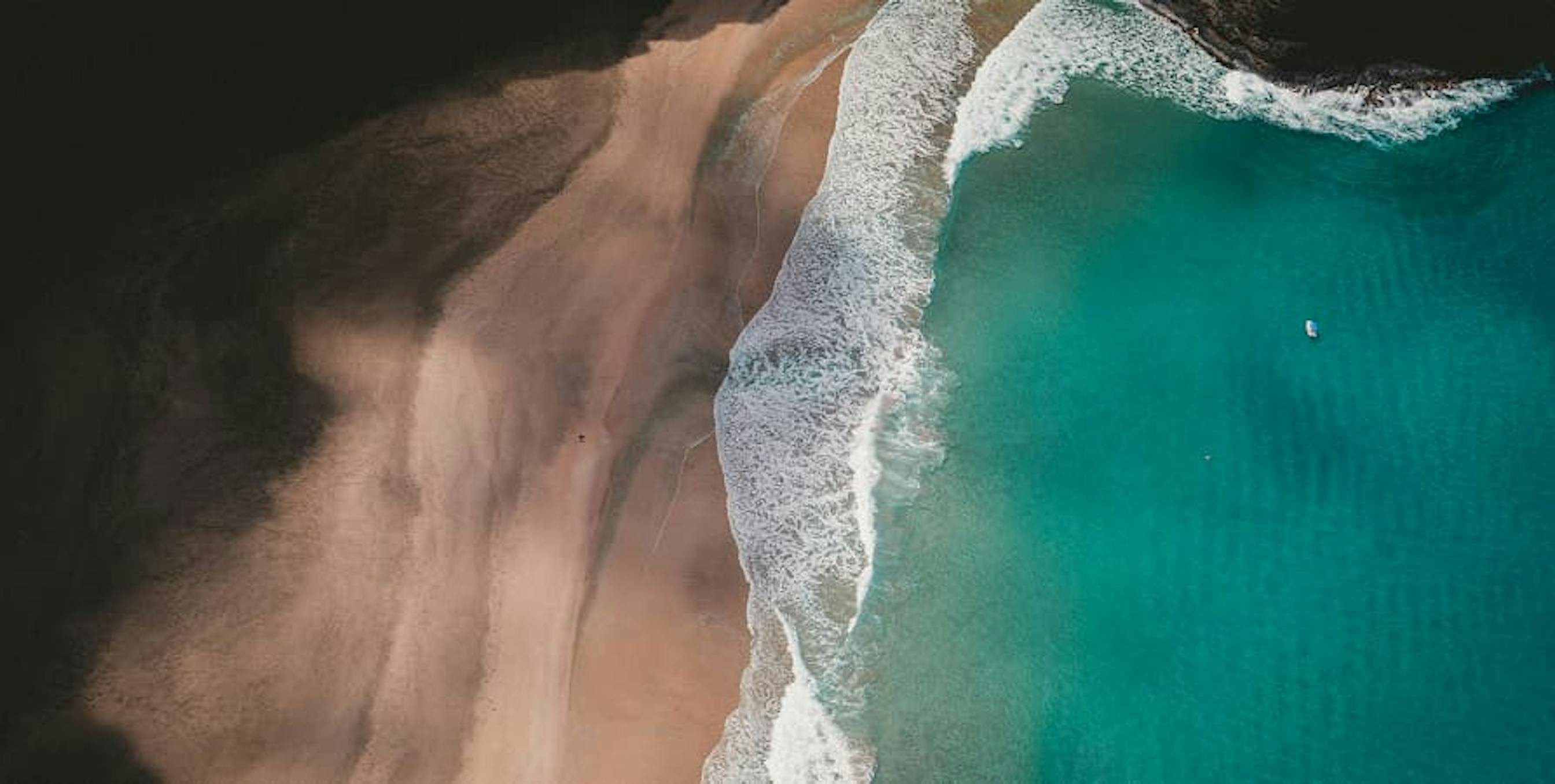 teal coastline from bird's eye view