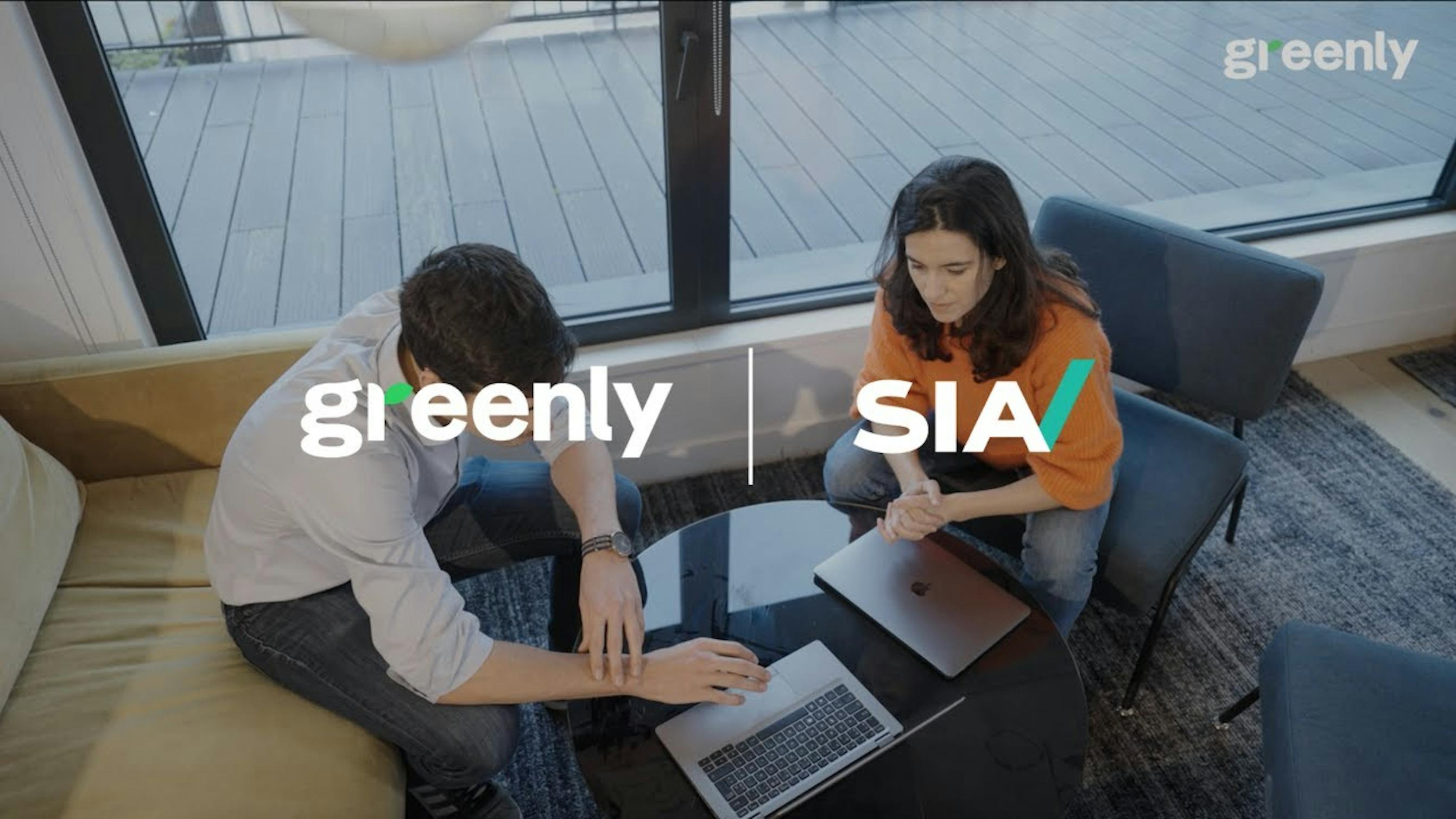 Video screenshot with two people sitting in front of a laptop