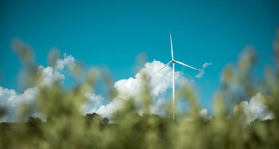wind turbine in blue sky green grass