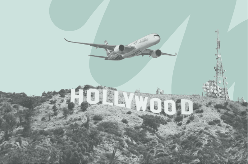 airplane flying over hollywood sign