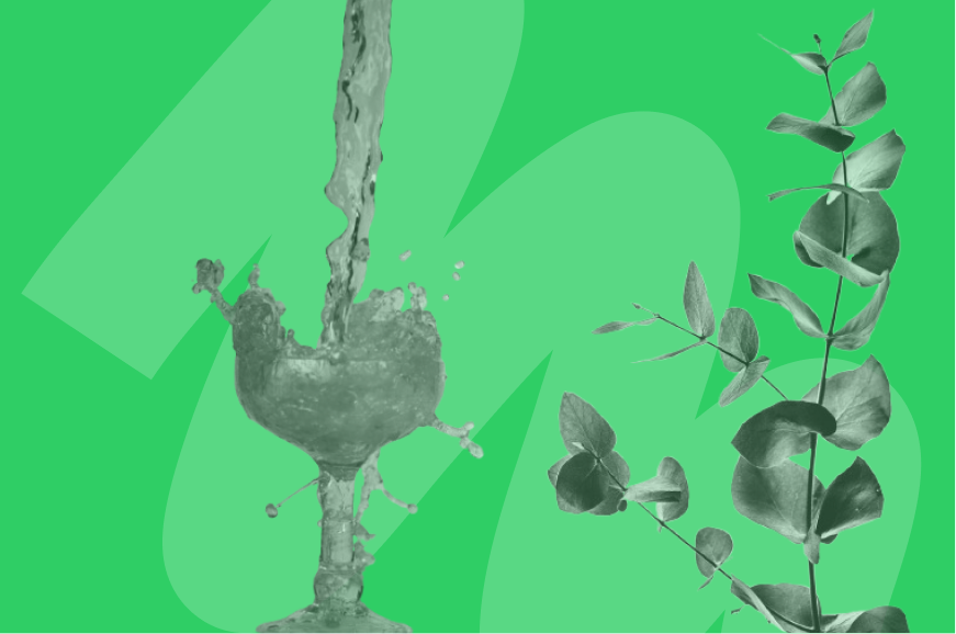 pouring green liquid into a cup with vine of leaves next to it