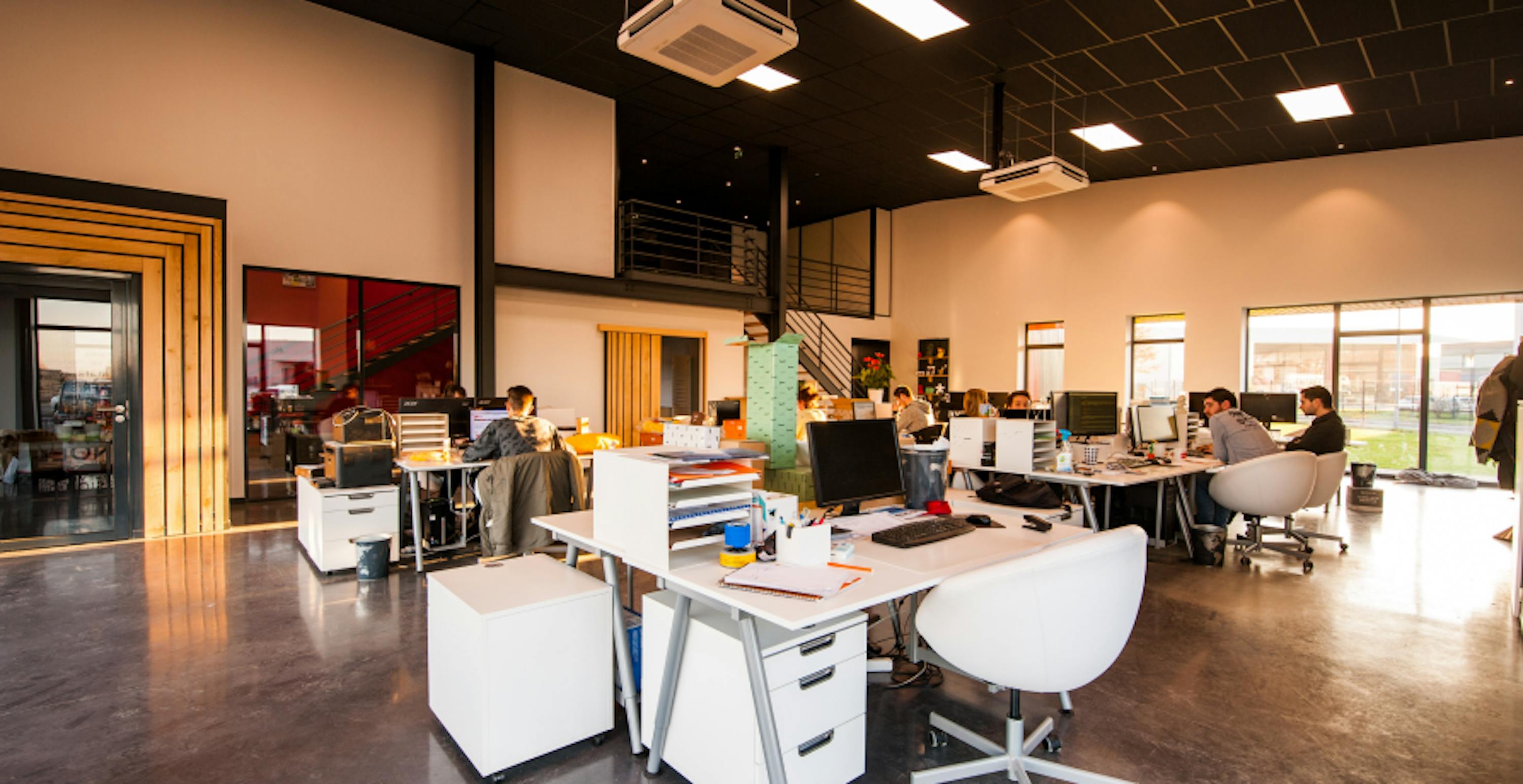 modern open plan office with lots of desks 