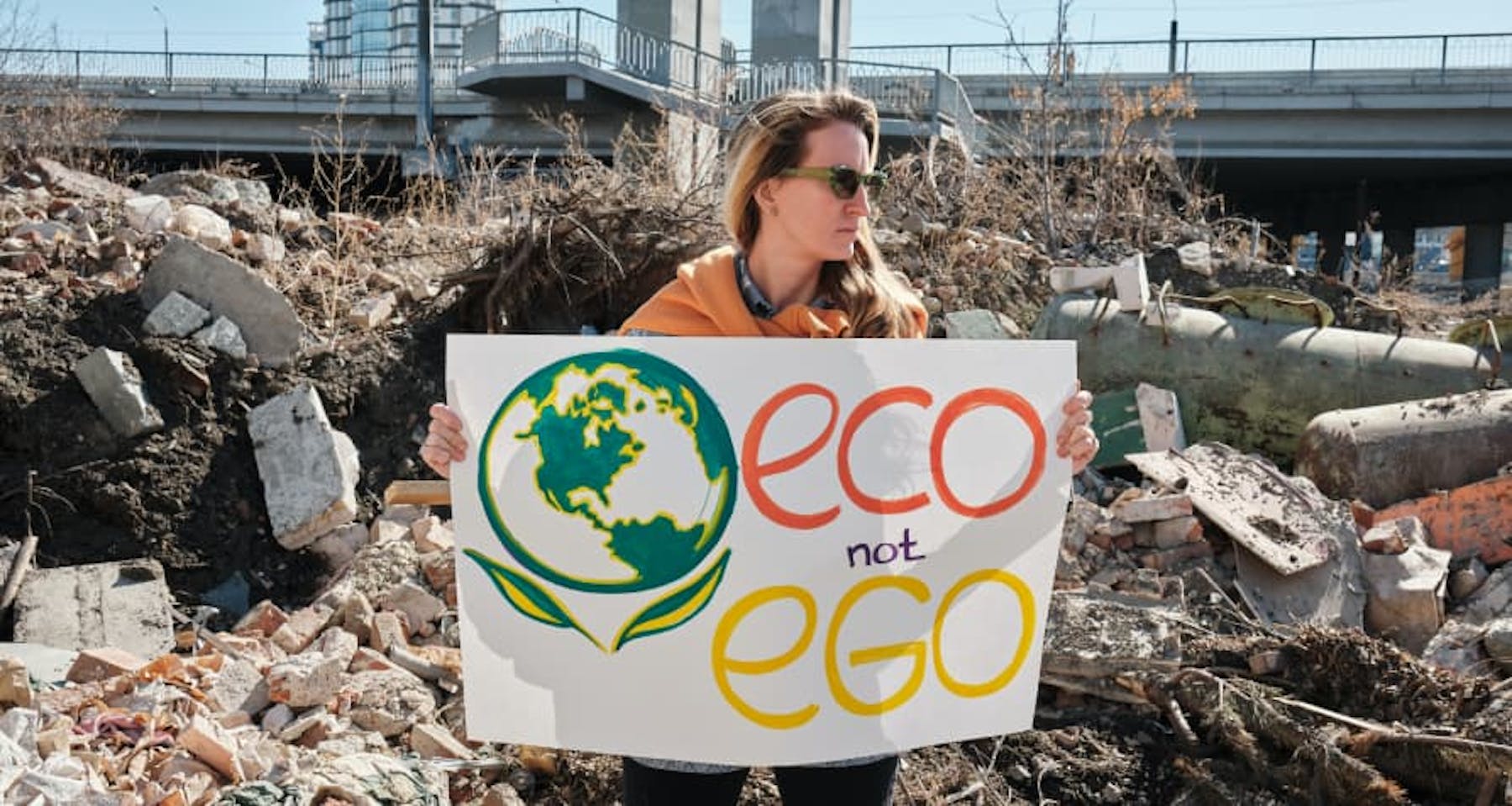 person holding sign eco not ego