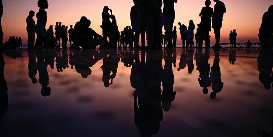 shadows of group of people at end of sunset