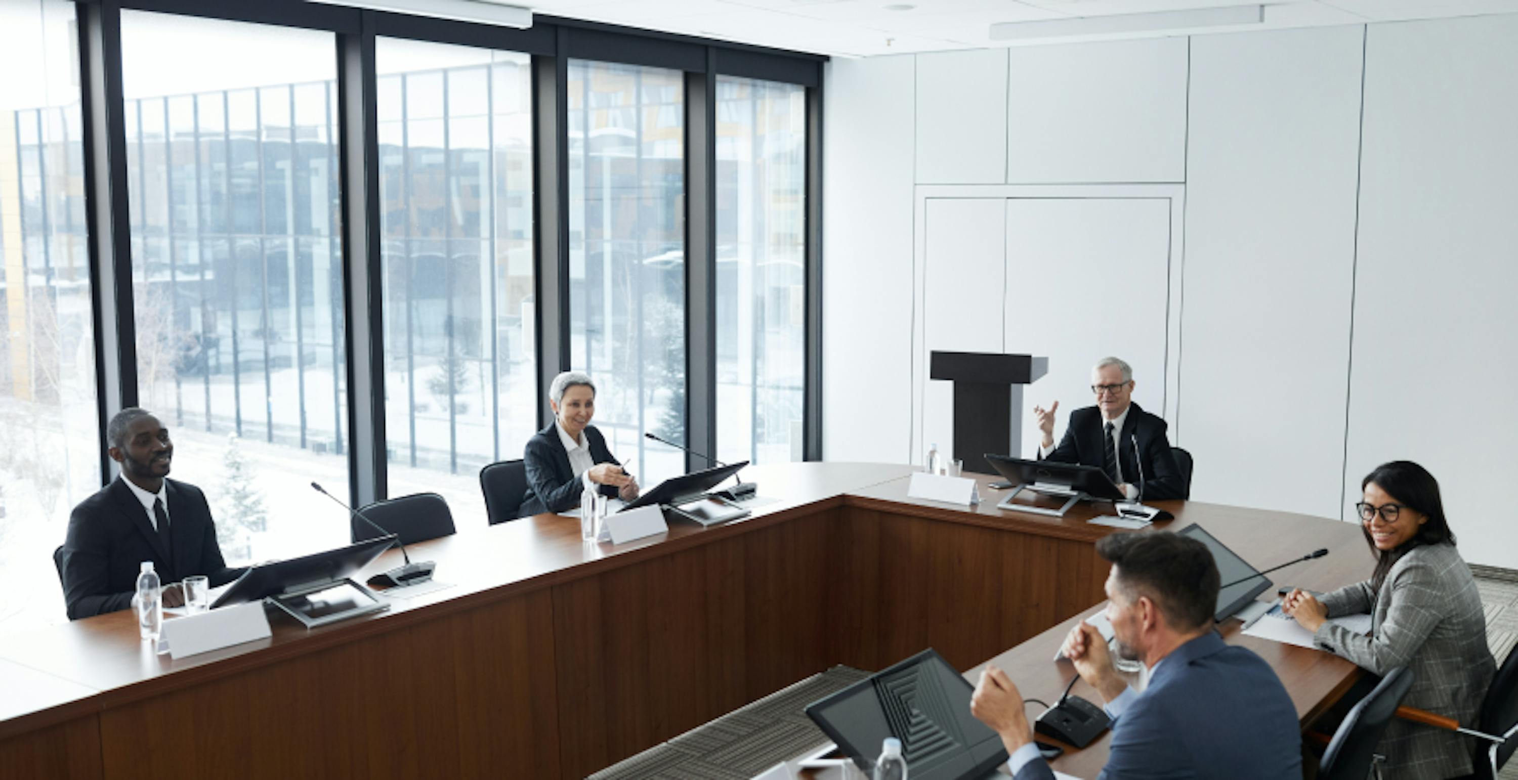 company boardroom with employees sitting in it