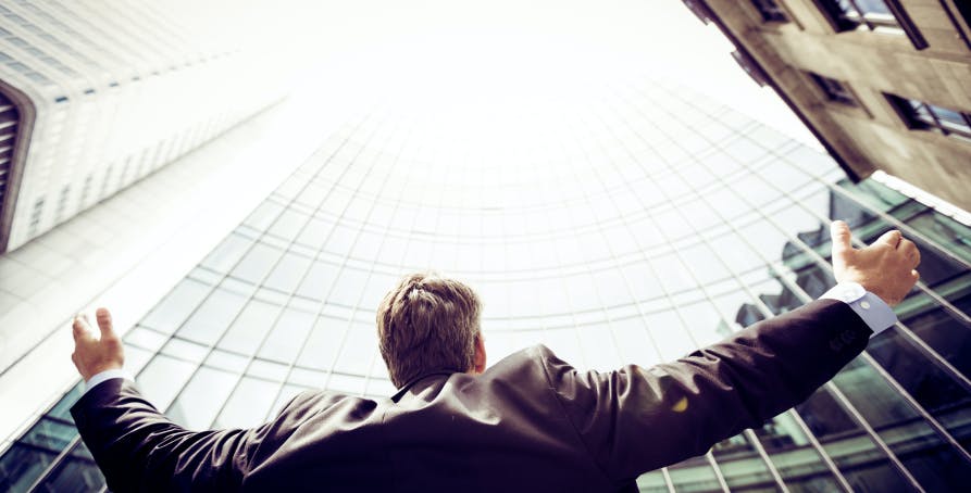 man standing in front of skyscapers