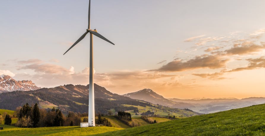 wind turbine with mountains in background