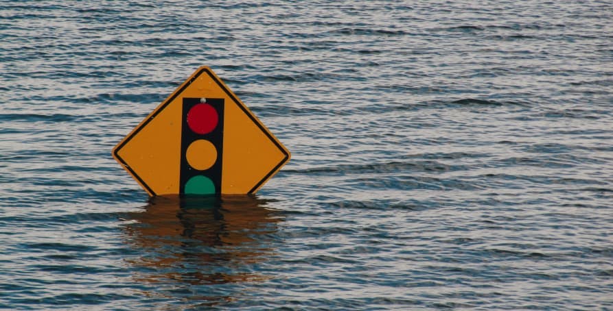 stop light sign sinking in water