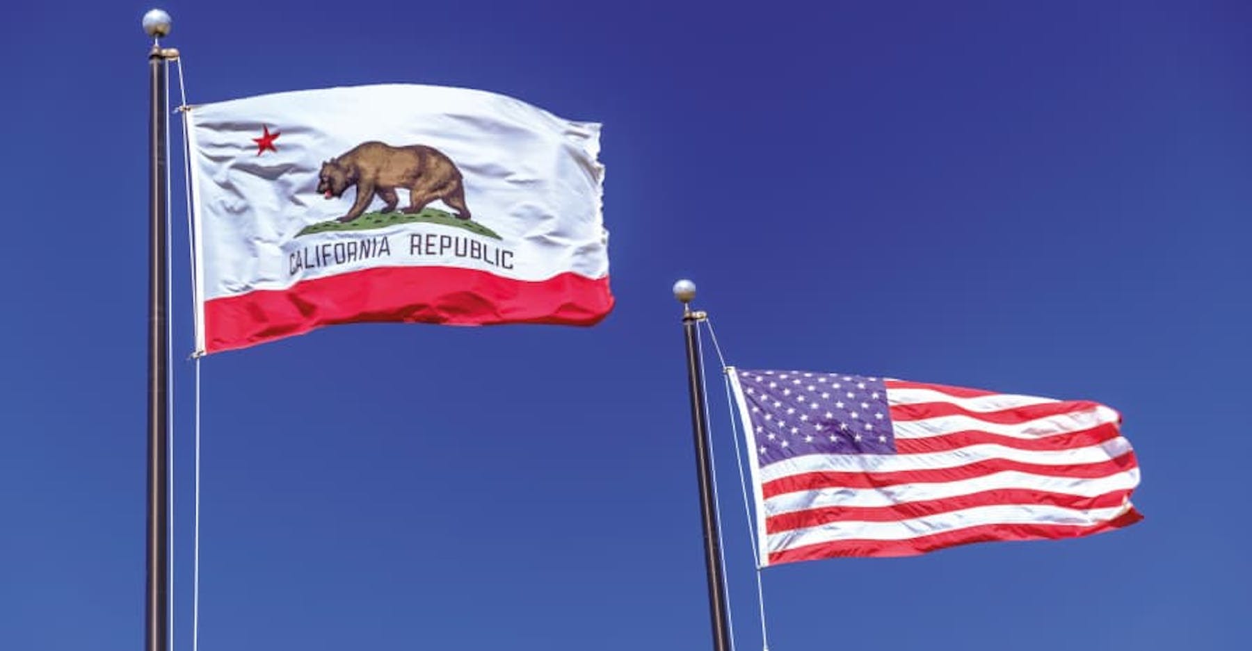 california flag and us flag navy blue sky