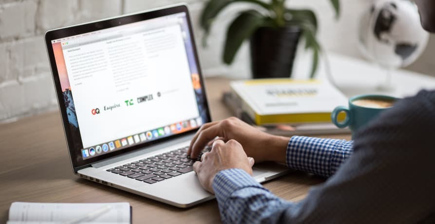 man working on the internet on his laptop at a desk