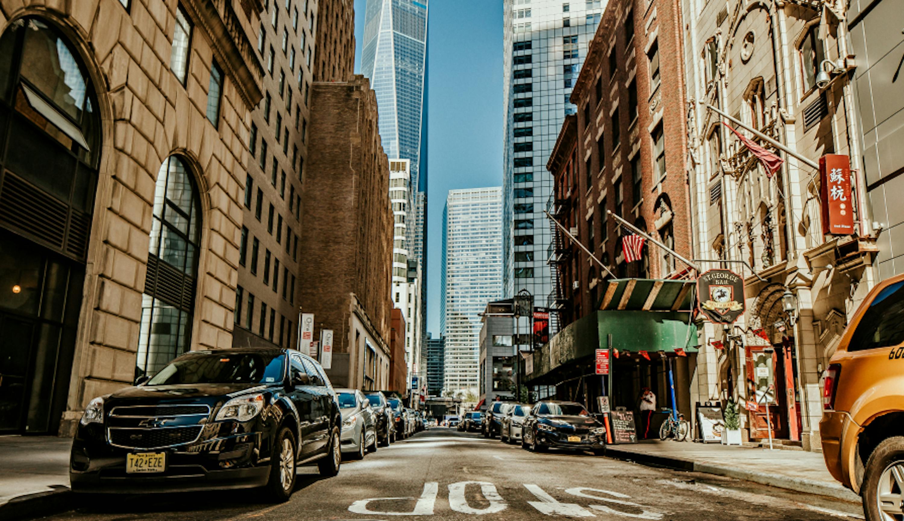 view of downtown nyc chinatown financial district sunny day one world trade center