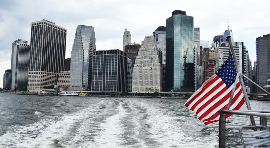 view of nyc from boat with us flag