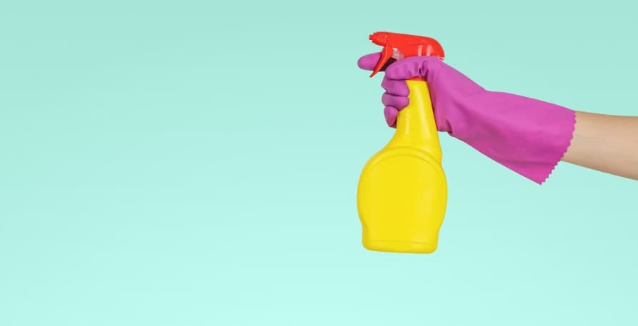 cleaning supplies purple glove yellow bottle