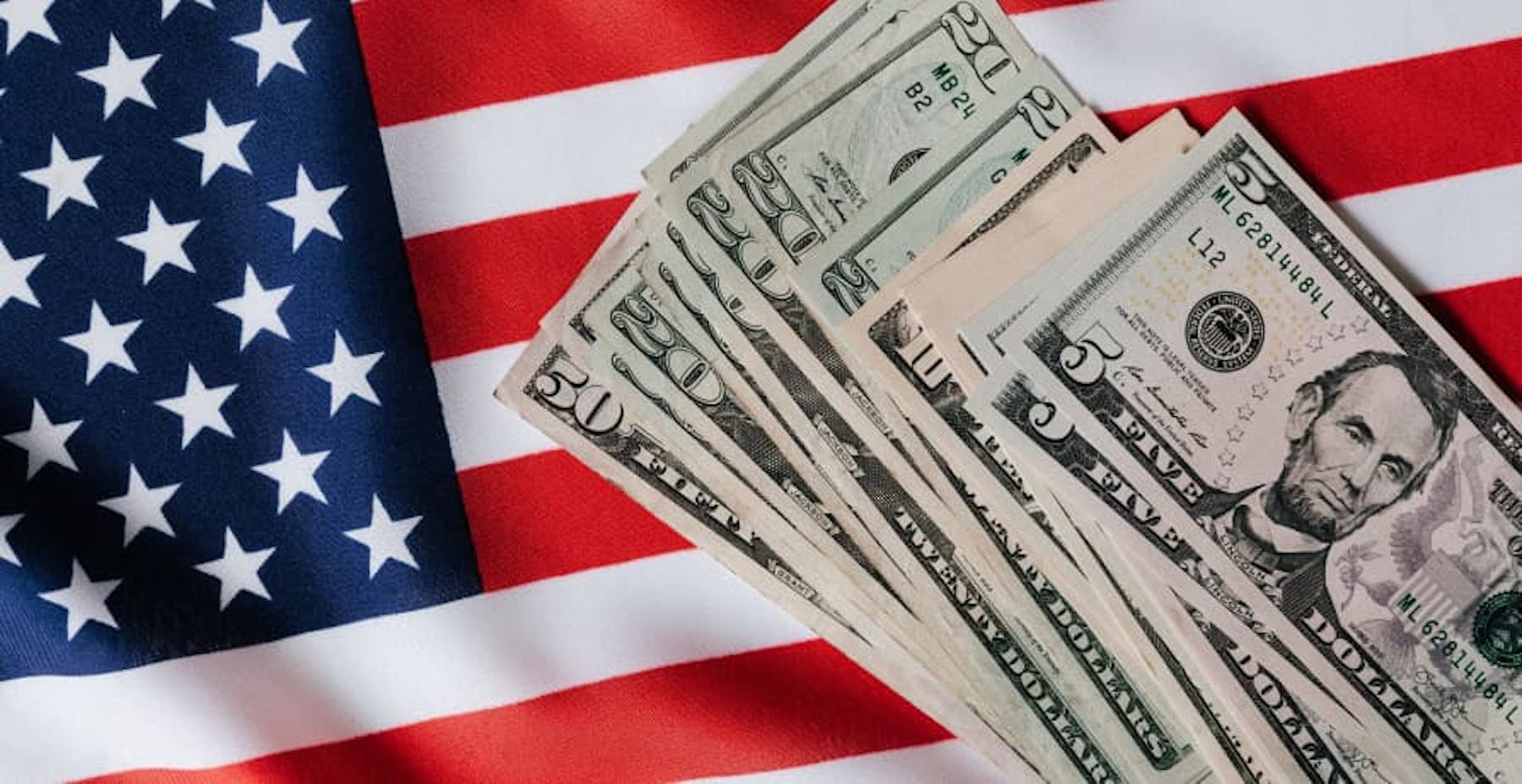 USD bills on US flag