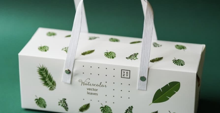 white package covered in green emoji leaves