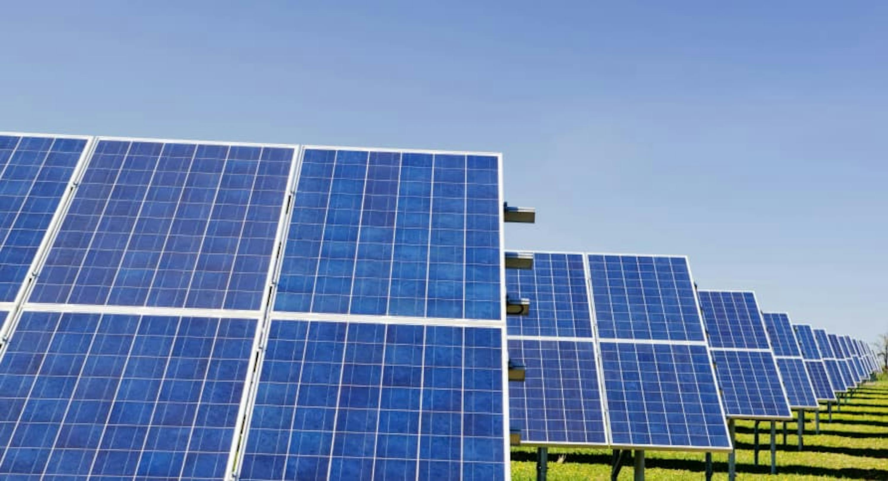 large solar panels in blue sky