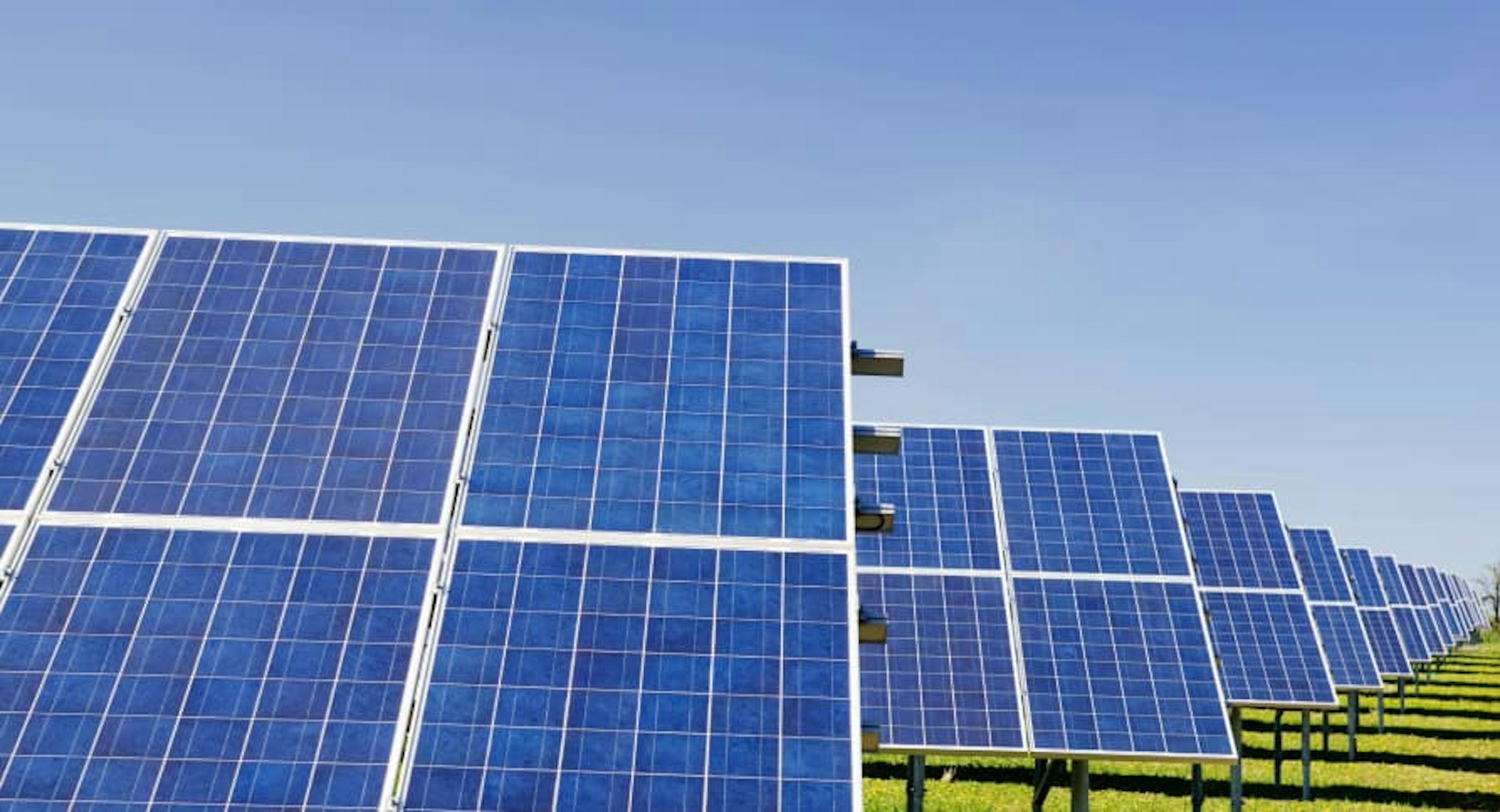 large solar panels in blue sky