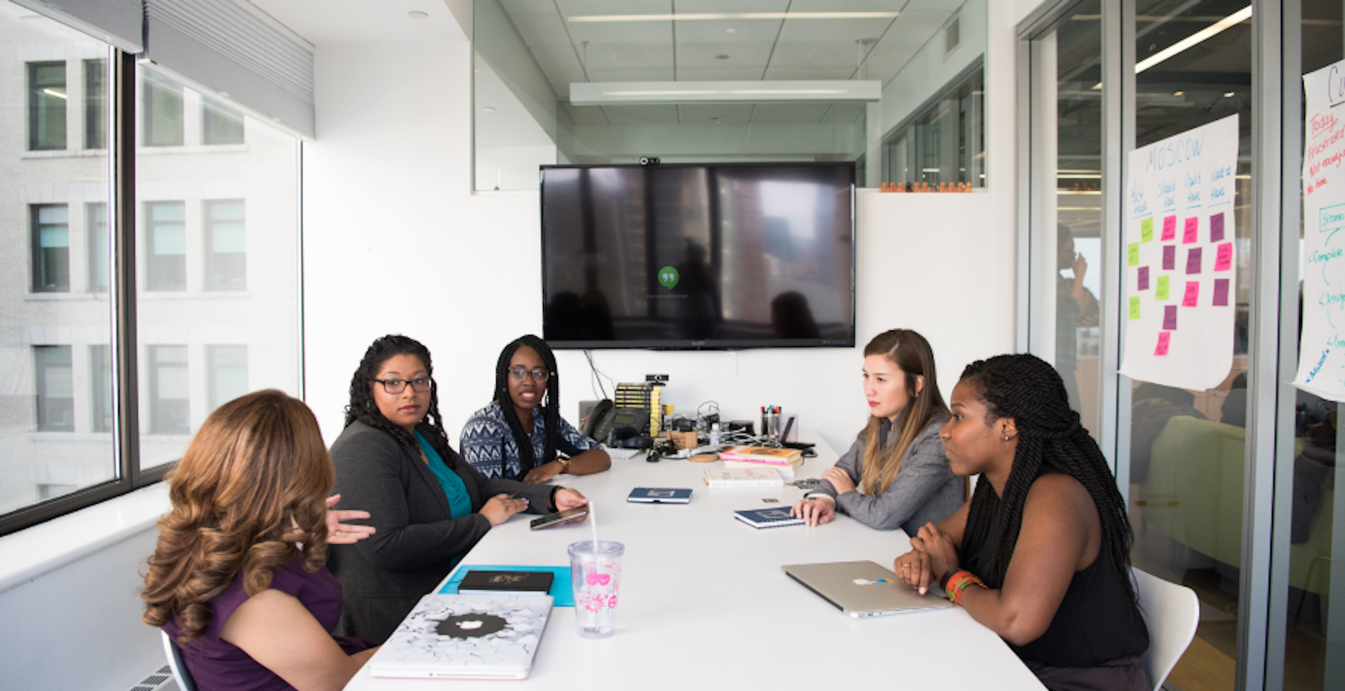 people in a meeting white table