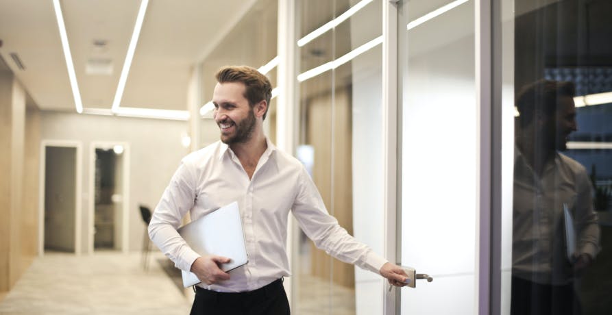 man going into meeting