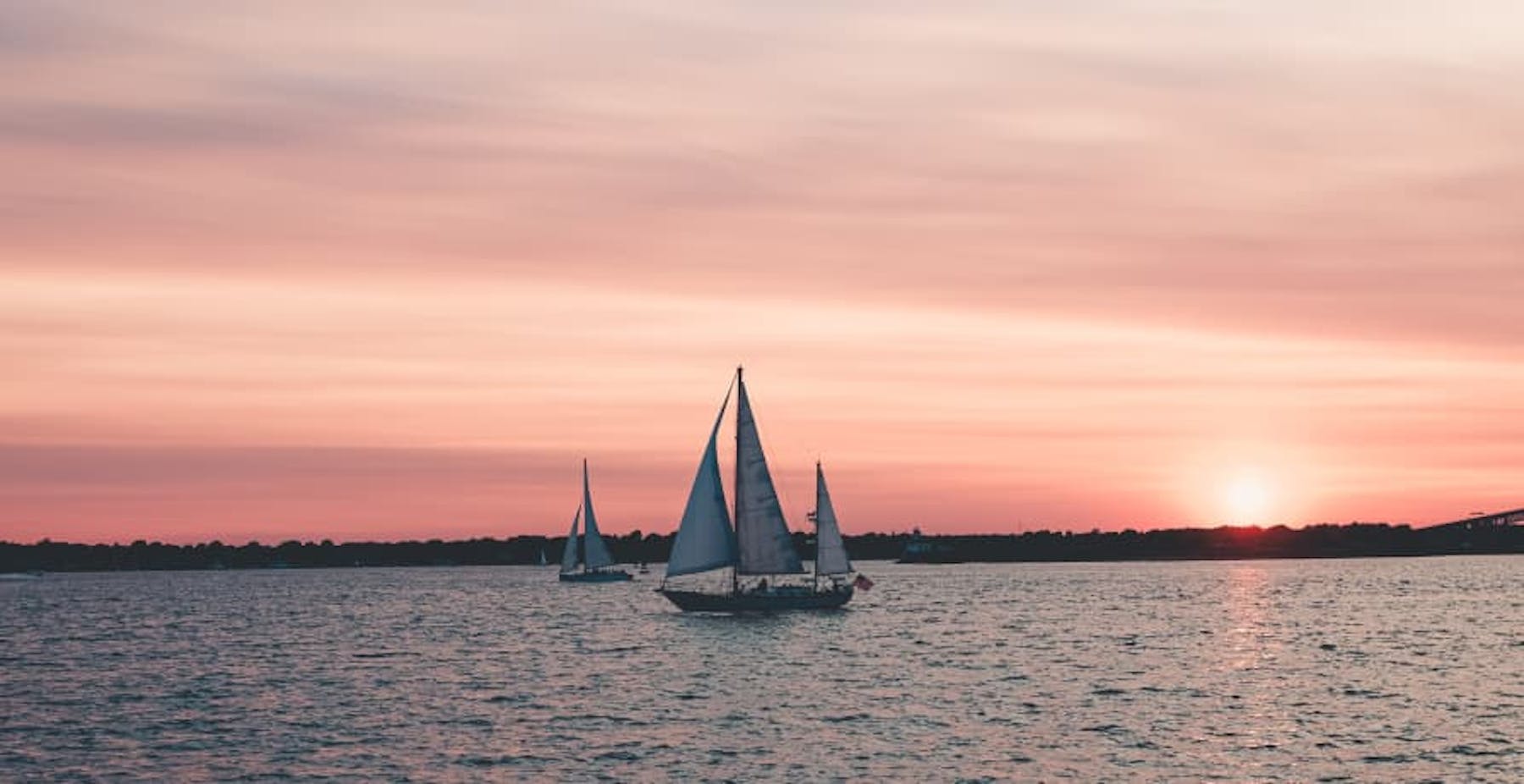 sunset sailboats in rhode island pink sky
