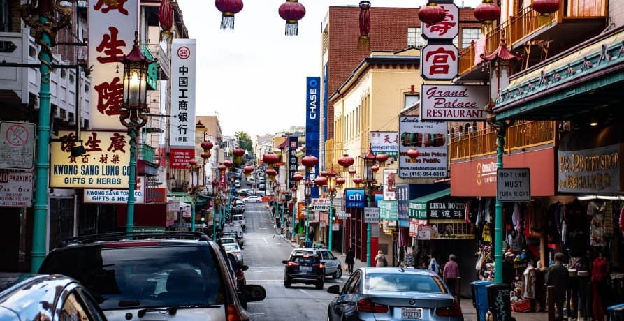 Busy street in a Chinese town with lots of cars and people