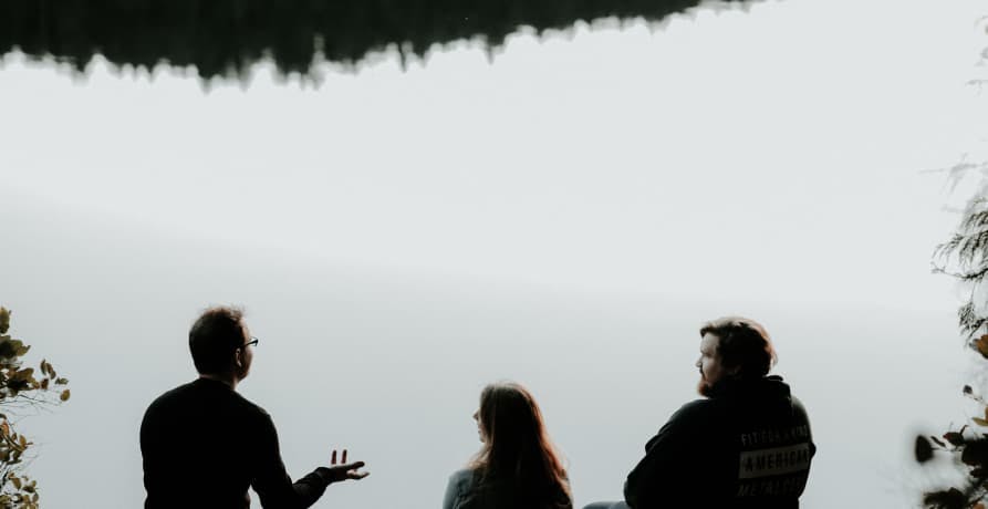 people talking near river