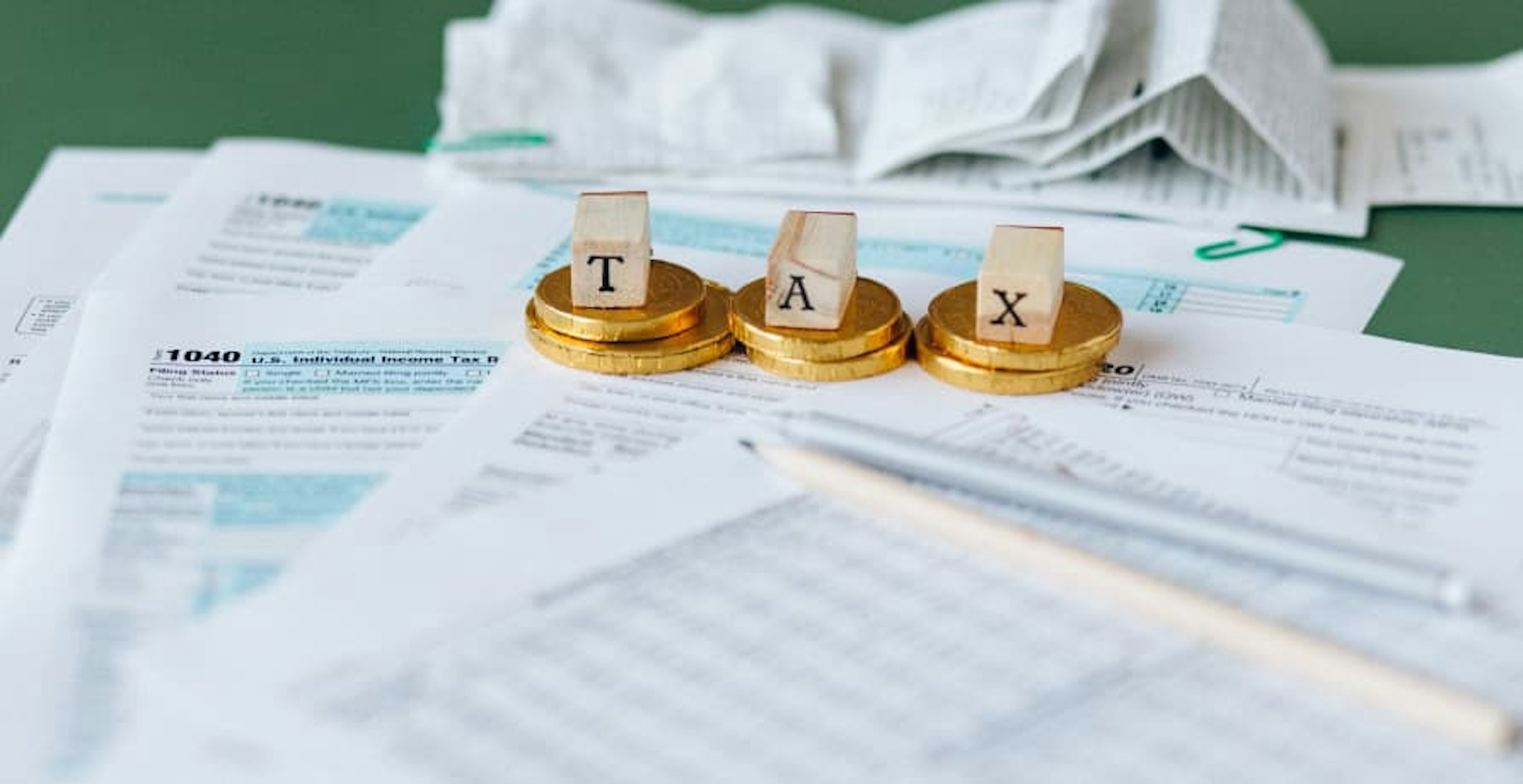 scrabble cubes spelling taxes over paperwork