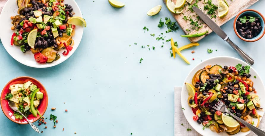 meals in white bowls on light blue counter