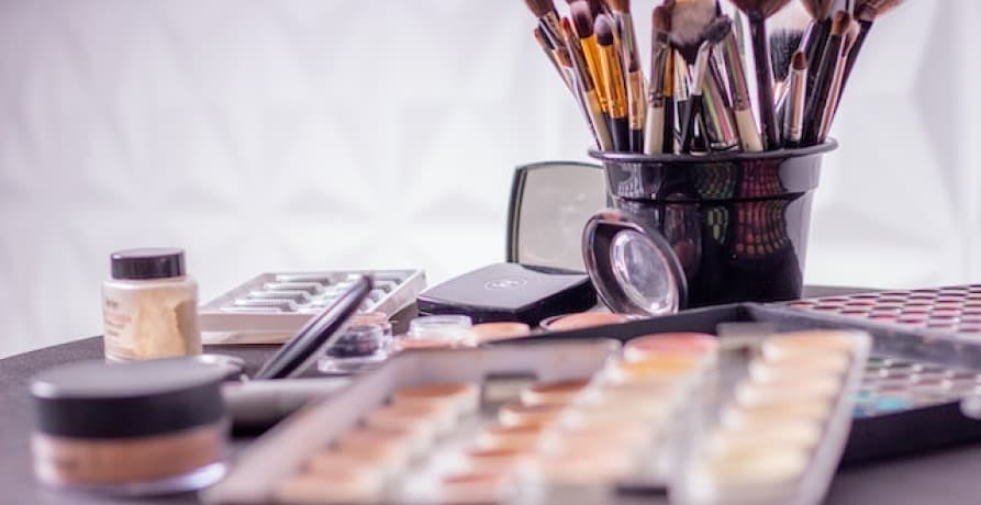 makeup brushes in bin and eyeshadow palette