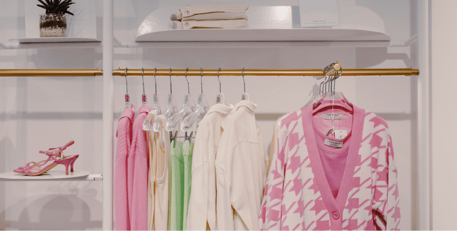 pink white and green clothes in minimalist closet