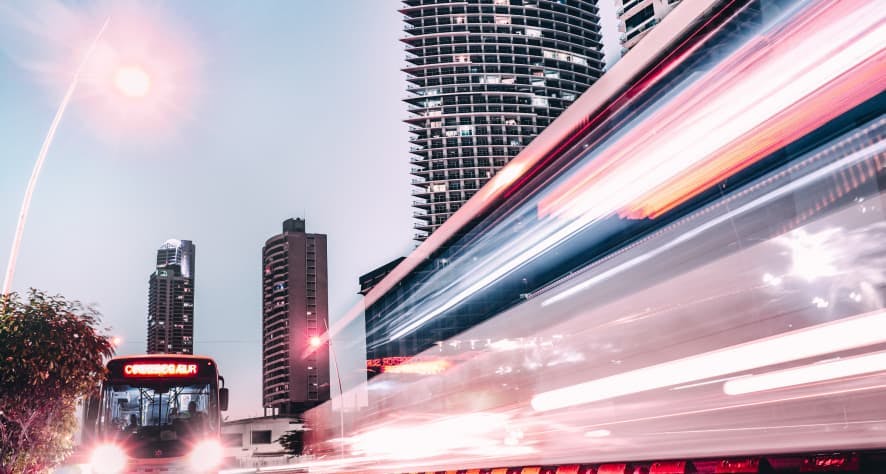 bus driving by fast in city at dusk