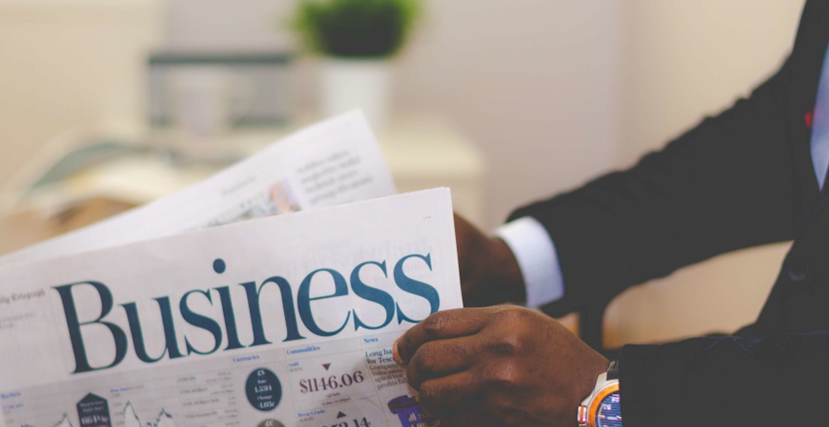newspaper with headline that reads, "business"
