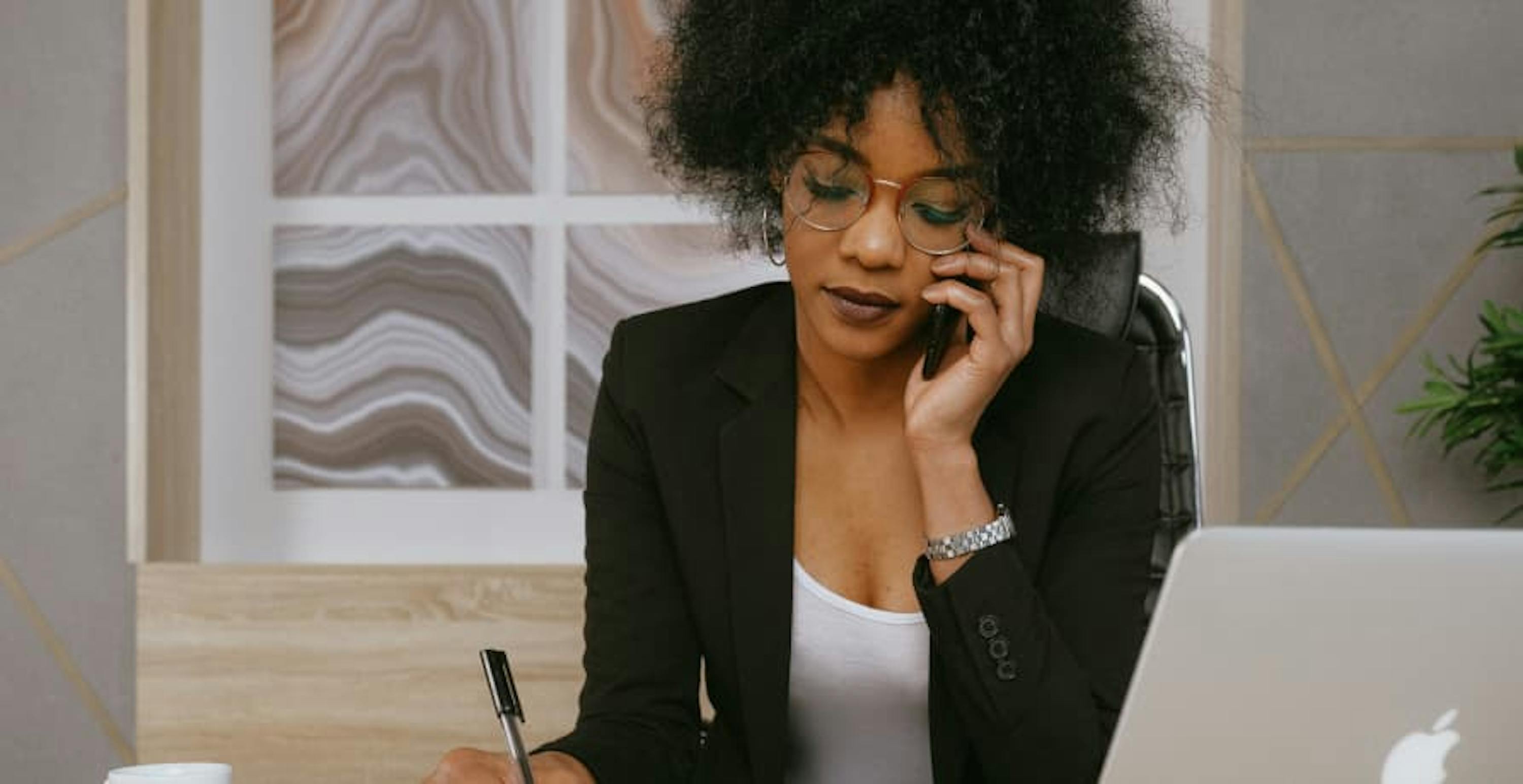 woman in suit on phone