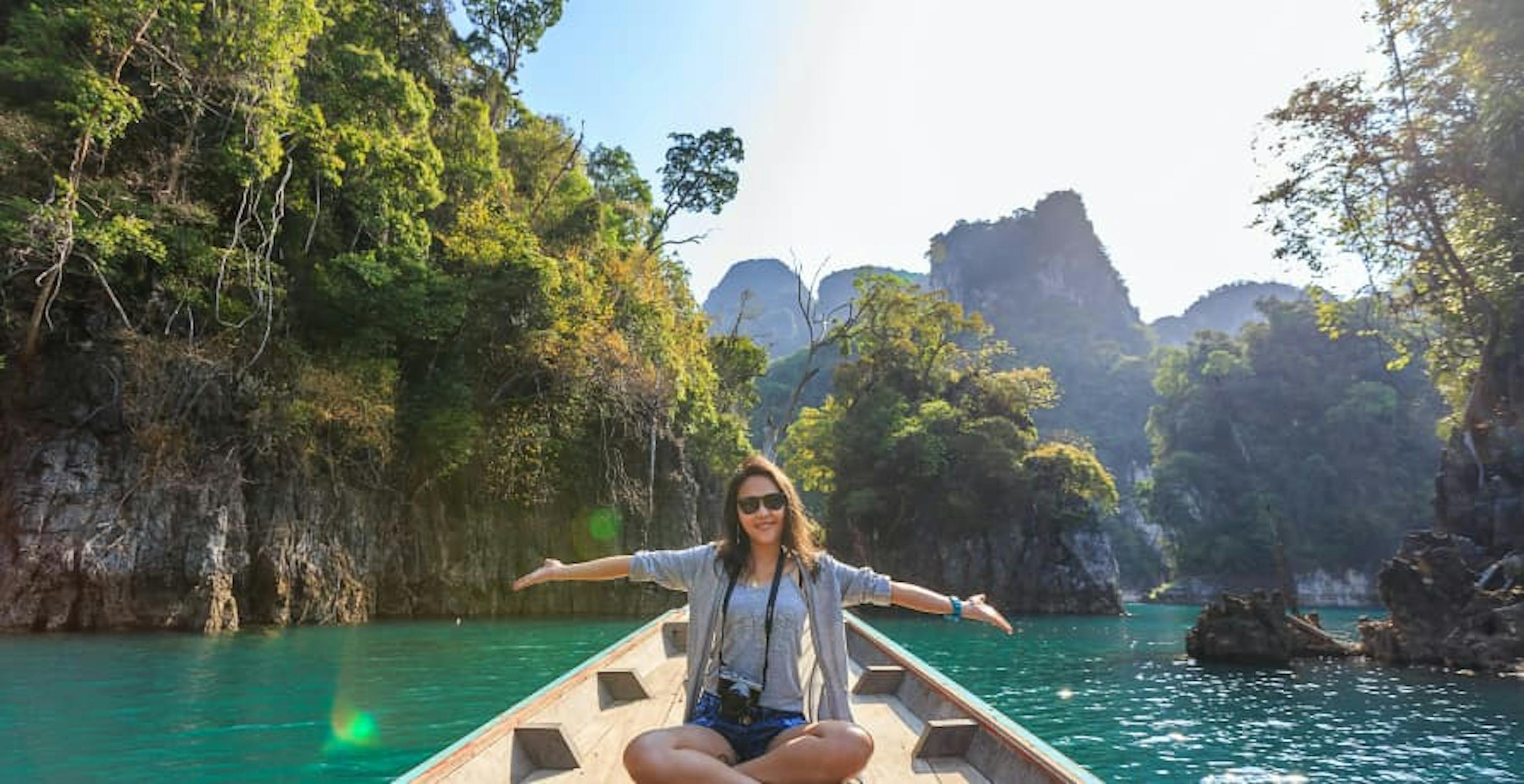 woman on a boat in the middle of a lagoon