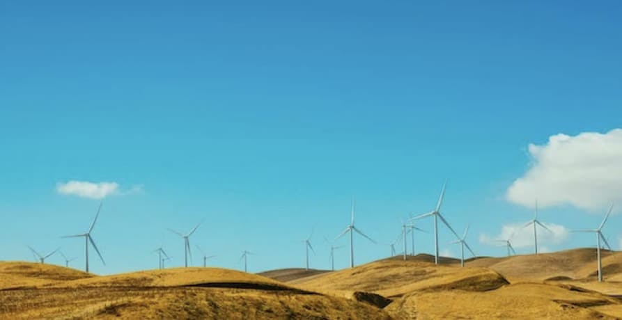 wind turbines under blue sky