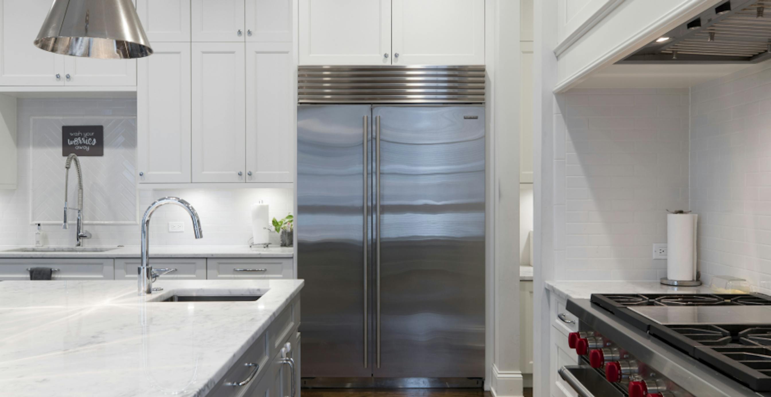 modern white and steel kitchen with view of fridge