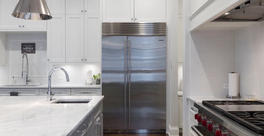 modern white and steel kitchen with view of fridge